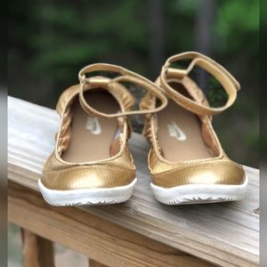 Nike gold flats with ankle strap